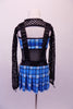 Blue & white tartan dress has pleated kilt style short shirt linked to the matching bra top via a large holed black fishnet torso. Leatherette suspenders originate from the skirt waistband & sit below a long-sleeved black fishnet shrug. Comes with large nerd glasses & fishnet thigh-high stockings with tartan trim. Back
