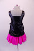 Hairdresser themed costume has black leatherette tunic style top with hand painted scissors, comb and blow drier. The tunic top ties at the sides and sits over top of a bright pink skirt with purple tricot petticoat. Comes with pink hairbow. Back