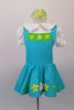Pinafore style white aqua dress has hand painted white, yellow and green flowers, pouffe sleeves and Peter Pan collared blouse style. The tricot ruffled petticoat is green and accents the pinafore and flowers. Comes with matching curly hair accessory. Front