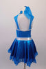 Shimmery turquoise blue crystal lined sweetheart bust dress has silver edging, sheer sparkle upper with a high collar. Back clips at neck with large keyhole opening. The skirt has sheer sparkle ruffle and petticoat with crystal buckle accented silver waistband. Comes with matching hair accessory. Back