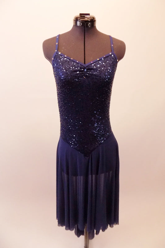Beautiful navy sequined leotard dress has intricately crossed back straps lined with crystal accents. The attached chiffon high-low skirt softens the look. Comes with crystal hair barrette. Front