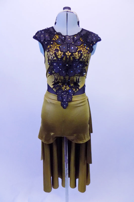 Antique gold short has attached long bustle skirt and is attached to the torso at the front by sheer black mesh. The gold torso is highlighted by a beautiful black embroidered floral lace scattered with crystals. The back is sheer black mesh that has a gold band and zipper. Comes with gold sequined headband. Front