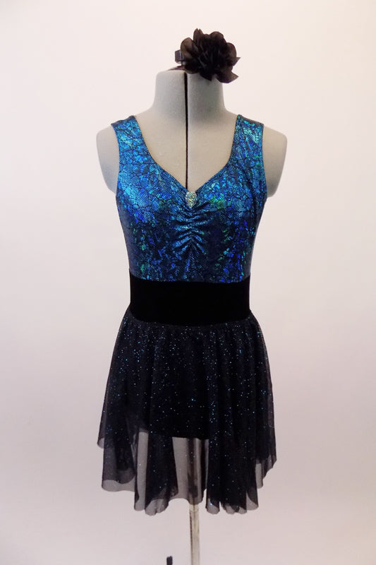 Blue-green scale pattered leotard has low scoop back and gathered bust. The accompanying pull-on skirt is a sheer black with shimmery sparkle. Comes with a hair accessory. Front