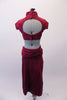 Modern russet coloured faux suede two-piece costume has knee length pencil skirt with, square panel front, large side slits & with a wide hip sash. The matching shrug style half-top has high neck collar & cap sleeves resting on a bra top. The back has bra closure & open keyhole back. Comes with a hair accessory. Back
