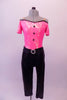 Fully sequined bright pink and black capri-length unitard is an off-shoulder top with black piping, cap sleeves, nude shoulder straps and black button accents. The attached black capri pat is a straight leg with gathered waistband and crystal ring buckle accent. Comes with a hair accessory. Front
