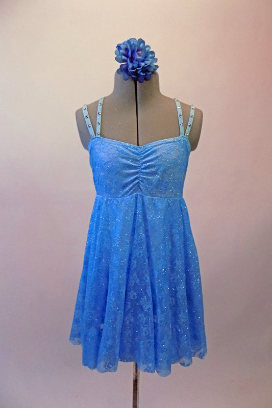 Pretty blue sequined sheer lace costume has an empire waist and gathered bust. The crystal covered double straps cross over at the back and provide a bit of bling. Comes with a floral hair accessory. Front