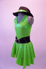Neon green halter collar dress has double crystaled vertical back straps.  The dress has a wide black waistband with circle crystal buckle accent. Comes with matching hat accessory. Side