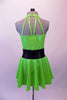Neon green halter collar dress has double crystaled vertical back straps.  The dress has a wide black waistband with circle crystal buckle accent. Comes with matching hat accessory. Back