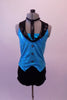 Glittery turquoise halter vest top has black lapels, button accents and an attached necktie collar. The costume comes with black bootie shorts. Front