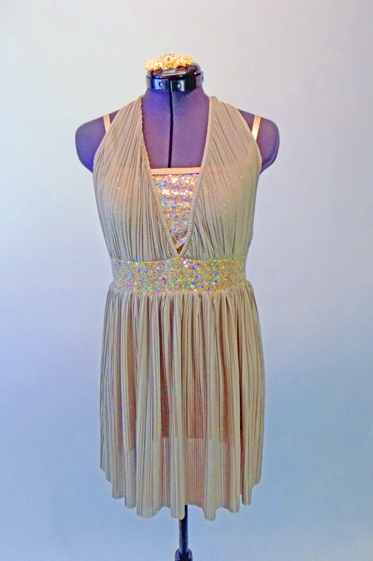 Delicate gold finely pleated dress has halter neck over a gold sequined tank style leotard. The wide gold sequined waistband separates the bust and soft pleated skirt. Comes with a gold hair accessory. Front