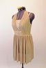 Delicate gold finely pleated dress has halter neck over a gold sequined tank style leotard. The wide gold sequined waistband separates the bust and soft pleated skirt. Comes with a gold hair accessory. Side