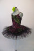 Pretty black pleated six-layer platter tutu has an attached bodice and overlay adorned with a glittery rose floral pattern in shades of pink, green and fuchsia. Comes with a green floral hair accessory. Side