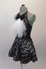 Black halter style dress has prominent silver swirled vine pattern. The neck has a large black bowtie from which cascades a large tulle layered ascot/bib. Comes with a black bowler hat. Side