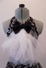 Black halter style dress has prominent silver swirled vine pattern. The neck has a large black bowtie from which cascades a large tulle layered ascot/bib. Comes with a black bowler hat. Front zoomed