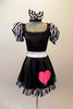 Sweet black dress has black and white striped pouffe sleeves and wide white waistband with large bow at back. The attached skirt has a black and white striped ruffle and a large pink sequined heart.  Comes with matching black and white striped hair bow. Front