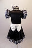 Sweet black dress has black and white striped pouffe sleeves and wide white waistband with large bow at back. The attached skirt has a black and white striped ruffle and a large pink sequined heart.  Comes with matching black and white striped hair bow. Back