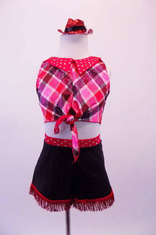 Two-piece cowboy themed costume has a pink, red and navy tartan half-top with red crystalled collar and tie front. The bottoms are a stretch denim short with red crystalled waistband and faux back pocket. The shorts are trimmed with red fringe for a western feel. Comes with sparkled mini cowboy hat and denim fringe. Front