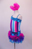 Costume has turquoise, crystal lined neckline with asymmetrical shoulder and straps with an adorable curly ruffled attached skirt in shades of blue pink and purple. The colours of the skirt compliment the striped vertical torso and the large pink hair accessory. Left side