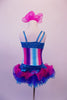 Costume has turquoise, crystal lined neckline with asymmetrical shoulder and straps with an adorable curly ruffled attached skirt in shades of blue pink and purple. The colours of the skirt compliment the striped vertical torso and the large pink hair accessory. Back
