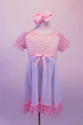 Empire waist dress has pale sequin speckled pink bust with pouffe sleeves. The knee length white flowing skirt had a matching pink ruffle and bow accent. Comes with pale pink hair bow clip. Front