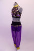 Costume has purple harem pants with gold coin trim hip accent. The halter style fully sequined half-top has double gold and black angled back straps. Comes with a gold hair accessory. Side