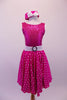 Fuchsia dress has sequined bodice with white crystal lined piping and low scoop back with a bow. The fuchsia and white polka dot skirt has petticoat for volume and a white belt with crystal circle buckle. The matching polka dot pill hat is scattered with crystals and a matching white bow. Front