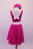Fuchsia dress has sequined bodice with white crystal lined piping and low scoop back with a bow. The fuchsia and white polka dot skirt has petticoat for volume and a white belt with crystal circle buckle. The matching polka dot pill hat is scattered with crystals and a matching white bow. Back