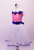 Romantic style ballet dress has pink glitter bodice with white crystal lined bust and cap sleeves. The bust and waist are embossed with royal blue 3-D sequined floral applique and large back bow. The attached white skirt is crystal-tulle with petticoat and trimmed with royal blue ribbon. Comes with a hair accessory. Side