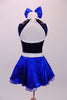 Blue-black costume has a diamond sequin bust with white trim open back and black leatherette crystalled collar. The attached blue skirt with crystal scattered organza overlay has a white belt with crystal buckle. Back