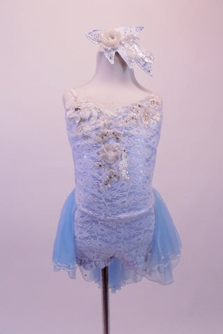 Ice blue & white lace lyrical costume is a short unitard with a front bodice covered with beautiful beaded & sequined white and silver appliques. The attached sheer blue layered bustle skirt creates a soft feel & compliments the lace ruffled legs & uniquely open back with low cross straps. Comes with hair accessory. Front