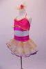 Two-piece costume has bright pink tie-up halter half top with tiny gold tulle ruffling and crystalled design accents at bust and back. The layered white and gold skirt is edged in gold and a purple ribbon with wide pink waistband has a crystal design that compliments the bust. Comes with matching hair accessory. Side
