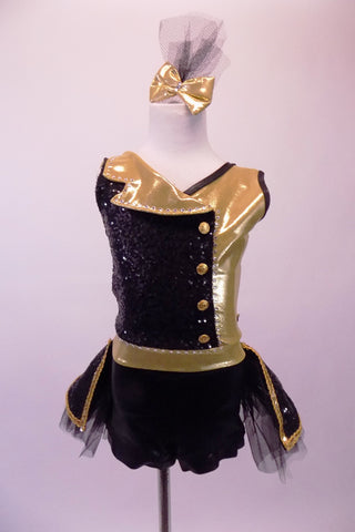 Black sequin & gold big band inspired short unitard has wrap front with gold accent side buttons & a crystal lined fold down lapel collar. The two sides of gold & black come together at the centre open back with a crystal ring buckle & attached back crystal bustle skirt with gold braiding & tulle. Comes with gold bow. Front