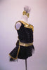 Black sequin & gold big band inspired short unitard has wrap front with gold accent side buttons & a crystal lined fold down lapel collar. The two sides of gold & black come together at the centre open back with a crystal ring buckle & attached back crystal bustle skirt with gold braiding & tulle. Comes with gold bow. Right side