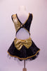 Black sequin & gold big band inspired short unitard has wrap front with gold accent side buttons & a crystal lined fold down lapel collar. The two sides of gold & black come together at the centre open back with a crystal ring buckle & attached back crystal bustle skirt with gold braiding & tulle. Comes with gold bow. Back