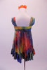 Deep jewel colours of blue red yellow & green combine in a 60s inspired hippie tie-dye style empire waist dress. The gathered bust gives rise to wide shoulder straps & a lower back. The knee length dress has a large ruffle at the bottom. Comes with an orange floral hair accessory. Back