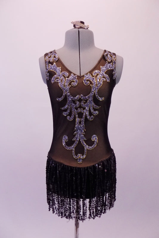 Brownish-grey V-neck leotard has gold-edged silver appliqués covering the entire front torso in a paisley-like pattern. The low V-back has matching paisley appliques which compliments the sequined fringe skirt. Comes with a hair accessory. Front