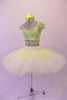 Professional pleated & hand tacked, 9-layer pancake tutu is two-piece. The tutu has an ivory basque & gold crystal tulle overlay with sequin accents & appliqued flowers. The bodice is a crop style top with pearl beaded fringe, gold & green sequined, applique floral lace & scalloped cap sleeves. Comes with hair flower. Left side