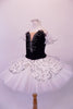 Pleated, hand tacked pancake tutu is a beautiful contrast of black & white. The tutu is scattered with crystals & has a silver sequined overlay. The black velvet bodice has a deep sweetheart cut with nude mesh centre & hand painted silver branch design. Comes with white tulle armbands and crystal hair barrette. Left side