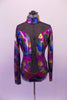 Long-sleeved high collar leotard in is iridescent fuchsia, blue charcoal & amber with a glittery black sheer mesh at front shoulders that extends down the front centre to hip. The sweetheart bust opens to reveal mesh that hugs the sides. Low, open back has two black vertical straps & one horizontal at mid back. Front