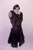 Black semi-sheer leotard dress has antique gold polka dots & is fully lined in the body. The bust is a low deep V with a black lace centre insert. The back is open with a single clip bra closure & the open sides curve into the front torso. The ruched glittery waistband compliments the attached polka dot skirt. Right side