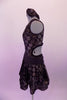 Black semi-sheer leotard dress has antique gold polka dots & is fully lined in the body. The bust is a low deep V with a black lace centre insert. The back is open with a single clip bra closure & the open sides curve into the front torso. The ruched glittery waistband compliments the attached polka dot skirt. Left side