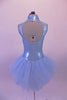Beautiful ice blue shimmery leotard has a front cut-out at bust with blue glitter mesh inlay. Hand-painted silver swirl design adorns the front of the bodice. The large open keyhole back compliments the soft tulle bustle skirt. Comes with silver hair barrette. Back