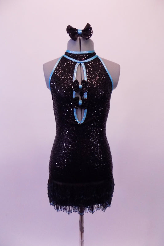 Jazz costume is a black fully sequined dress with pale blue piping. The attached hip skirt is a fully beaded black & blue fringe. The torso has a peek-a-boo hole with two small bow accents that keep it closed. The large open back has a nude horizontal strap to keep the front in place. Comes with a black sequined bow. Front