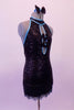 Jazz costume is a black fully sequined dress with pale blue piping. The attached hip skirt is a fully beaded black & blue fringe. The torso has a peek-a-boo hole with two small bow accents that keep it closed. The large open back has a nude horizontal strap to keep the front in place. Comes with a black sequined bow. Right side