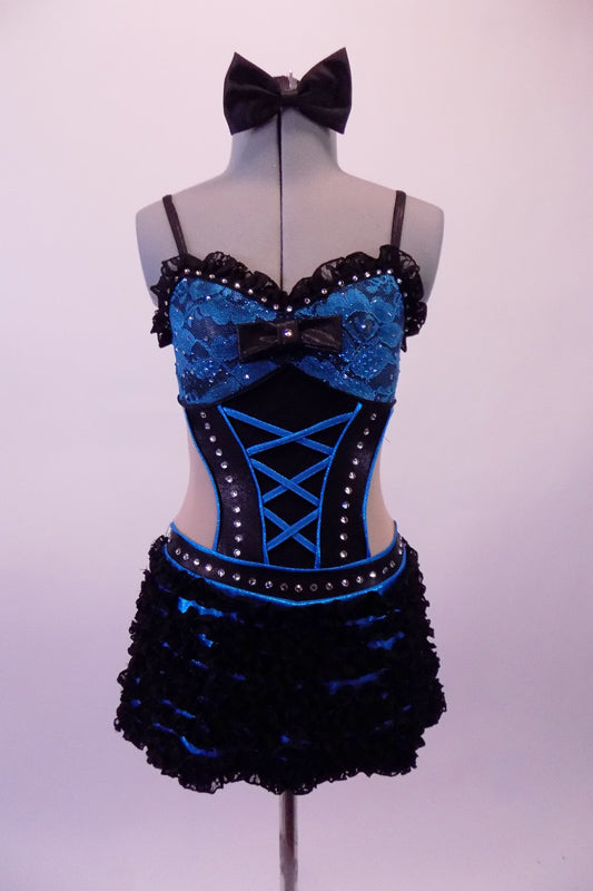 Blue & black leotard has a blue lace bra with black lace ruffle, crystal accents & bow front detail. The torso with open back and sides has a faux corset front, lined down the sides with crystals. The attached blue mini skirt is covered with layers of this black mini chiffon ruffle &has a large blue bow at the back. Front