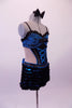 Blue & black leotard has a blue lace bra with black lace ruffle, crystal accents & bow front detail. The torso with open back and sides has a faux corset front, lined down the sides with crystals. The attached blue mini skirt is covered with layers of this black mini chiffon ruffle &has a large blue bow at the back. Right side