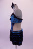 Blue & black leotard has a blue lace bra with black lace ruffle, crystal accents & bow front detail. The torso with open back and sides has a faux corset front, lined down the sides with crystals. The attached blue mini skirt is covered with layers of this black mini chiffon ruffle &has a large blue bow at the back. Left side