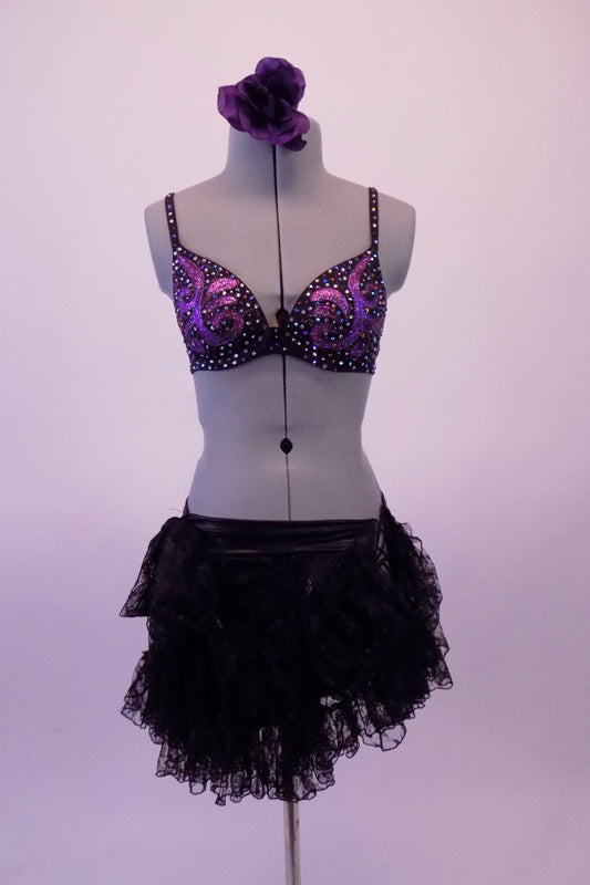 2-piece costume has a stunning hand painted bra with purple swirls & clad with many Swarovski crystals. The lace ruffled layered skirt has a leather-like waistband & a unique side that is open & held together via lacing & gives the appearance of an open side. Comes with a lace fan and purple rose hair accessory. Front