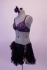 2-piece costume has a stunning hand painted bra with purple swirls & clad with many Swarovski crystals. The lace ruffled layered skirt has a leather-like waistband & a unique side that is open & held together via lacing & gives the appearance of an open side. Comes with a lace fan and purple rose hair accessory. Side