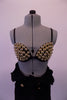 Funky costume comes with a black so-free bra covered in large gold bobbles and lined black high waisted pants  There is a black military style crop jacket with open front, gold buttons, and gold shoulder stripes that sits over top of the bra. Comes with gold stripped wrist gauntlets. Front of bra zoomed